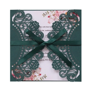 Deep green laser-cut wedding invitation cover with a silk ribbon and floral inner card