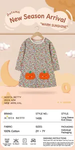 Detail view of floral cotton dress with orange pumpkin embroidery and size chart info