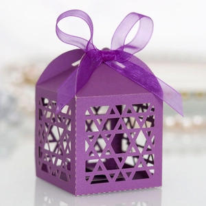 Macro shot of purple laser-cut star candy box with matching silk ribbon and bow