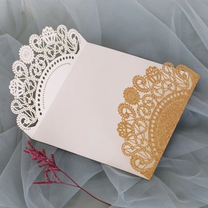 Detailed laser-cut hollow lace wedding invitation with gold glitter on soft blue tulle