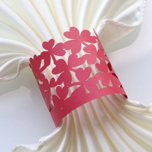 Laser-cut red paper napkin ring with heart and clover pattern for wedding decoration