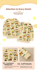Detail of yellow toddler sweatshirt showing construction vehicle patterns and ribbed cuffs