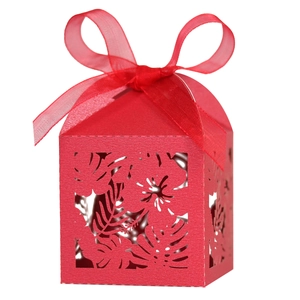 Detail view of red hollow laser-cut hibiscus candy box with matching sheer ribbon bow