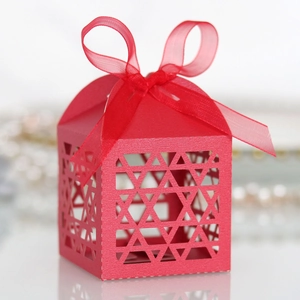 Detail view of red laser-cut candy box with Star of David patterns and organza ribbon