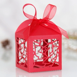 Detail of red laser-cut rose candy box with an elegant organza ribbon bow