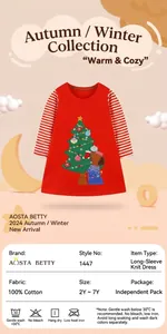 Detail view of red cotton dress showing embroidered Christmas tree and puppy design
