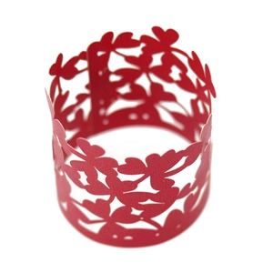 Macro detail of red laser-cut floral paper napkin ring for party and wedding decor