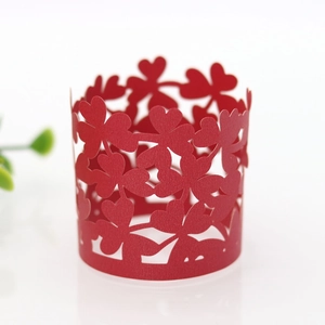 Macro detail of red laser-cut four-leaf clover paper napkin ring for party decor