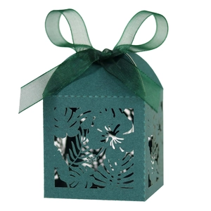 Deep green laser-cut gift box with tropical leaf patterns and matching silk ribbon