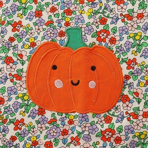 Autumn style girls pumpkin embroidered patch on floral background for Halloween dress