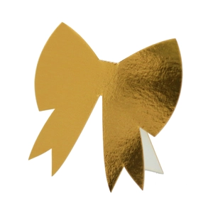 Macro shot of 3D gold paper bow card with laser-cut metallic reflective texture