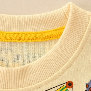 Close-up of ribbed neckline on yellow kids cotton sweatshirt with cartoon print