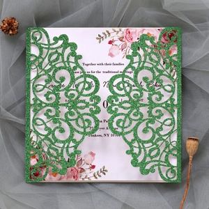 Detailed laser-cut wedding invitation featuring sparkling green glitter and floral patterns