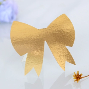 Detailed view of 3D gold bow decoration for wedding place cards with metallic texture