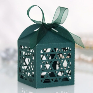 Detailed view of laser-cut Star of David pattern on a dark teal cardstock gift box