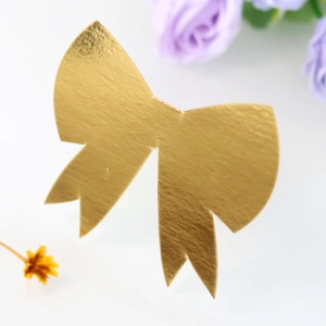 Macro shot of gold 3D bow place card with metallic texture for wedding table setting
