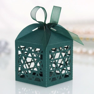 Detail of laser-cut David star pattern on dark green gift box with silk ribbon