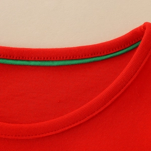 Red knit girls dress with crew neck and green contrast trim on the soft cotton collar