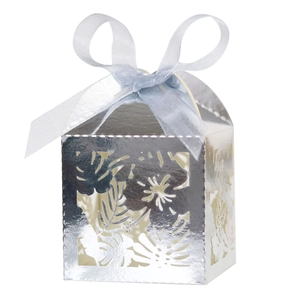 Silver laser-cut hollow gift box with palm leaf patterns and a blue ribbon bow detail