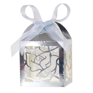 Detailed laser cut rose patterns on silver candy gift box with blue ribbon bow decor