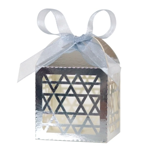 Detailed view of silver cutout star favor box with a decorative satin ribbon bow