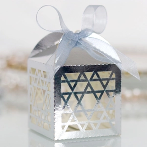 Detail of silver laser-cut gift box with hexagram patterns and light blue ribbon bow