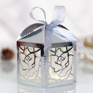 Detailed silver laser-cut rose gift box with a light blue ribbon bow for weddings