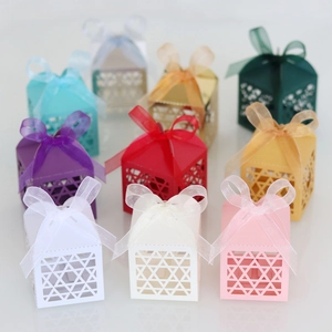 Detailed laser-cut star favor boxes with organza ribbons in nine diverse colors