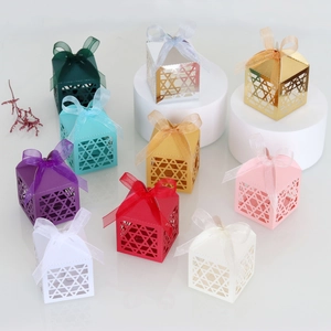 Close-up of assorted laser-cut gift boxes with geometric patterns and organza ribbons