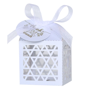 Detail of white gift box with laser-cut star pattern, silk ribbon and Thank You tag