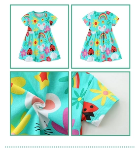 Detail view of cotton summer girl dress with mint green cartoon animal and floral print