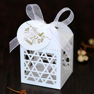 Detail of laser-cut star pattern candy box with Thank You tag and organza ribbon