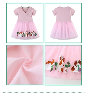 Detail of pink tutu dress featuring delicate floral and guinea pig embroidery on mesh