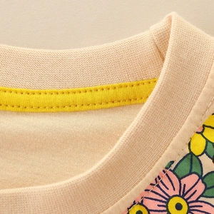 Girls' cotton t-shirt featuring a ribbed crew neck with decorative yellow inner seam binding