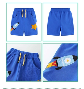 Detailed view of kids knit shorts featuring rocket embroidery and yellow drawstring