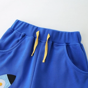 Boys royal blue knit shorts featuring elastic waist, yellow drawstrings and rocket embroidery