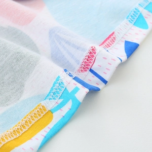 Close-up of high-quality stitching and colorful cartoon print on cotton girls' dress