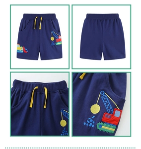 Detail view of navy blue cotton shorts with yellow drawstring and excavator embroidery