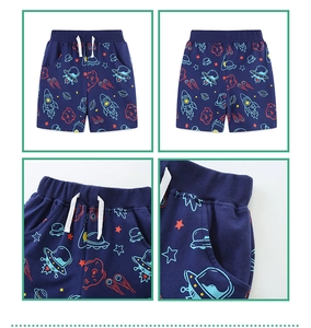 Detail view of navy blue boy's shorts with rocket space print and drawstring waist