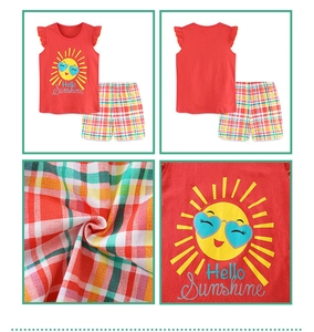 Detail of red sleeveless top and plaid shorts set with Hello Sunshine cartoon sun print