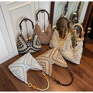 Detail view of woven crochet hobo bags with decorative large wooden bead handles