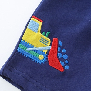 Boys navy knit shorts featuring detailed yellow construction vehicle embroidery on the front
