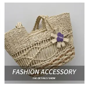 Detail shot of handwoven straw tote with purple butterfly embroidery and textured finish