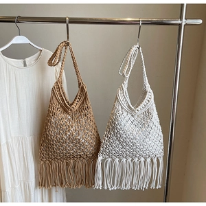 Detail of bohemian crochet tote bags with long fringe and mesh weave texture