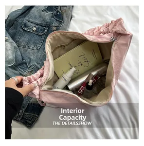 Internal view of pink hobo tote bag showing large capacity for books and cosmetics