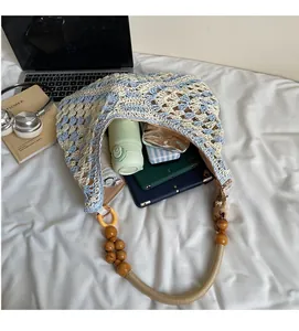 Interior view showing large capacity of woven tote bag with iPad, umbrella and sunglasses