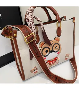Detail of wide woven strap with lettering and leopard print scarf on beige tote bag