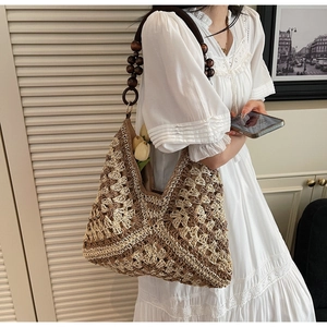 Detail of bohemian crochet tote with contrast paneling and wood bead strap accents