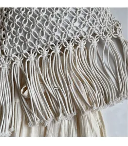 Close-up detail of Bohemian cream woven tote bag showing diamond mesh and tassel fringe