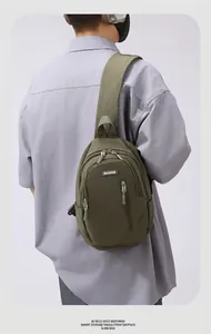 Detail showing military green nylon crossbody bag with adjustable wide strap and zipper pockets